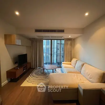 Modern living room with cozy sectional sofa and stylish decor in a well-lit apartment.