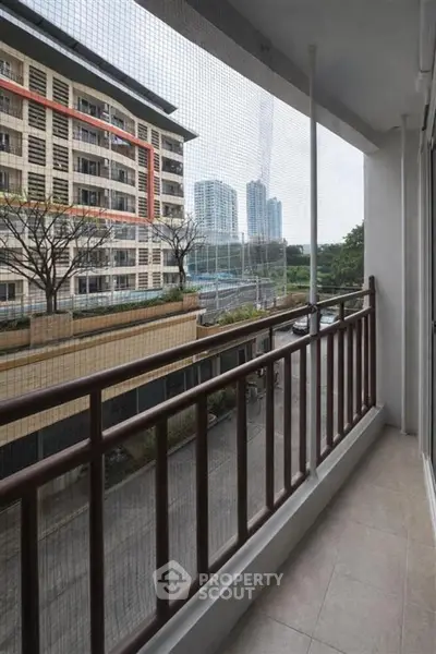 Spacious balcony with city view in modern apartment building