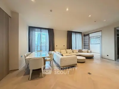 Spacious modern living room with elegant furniture and large windows.