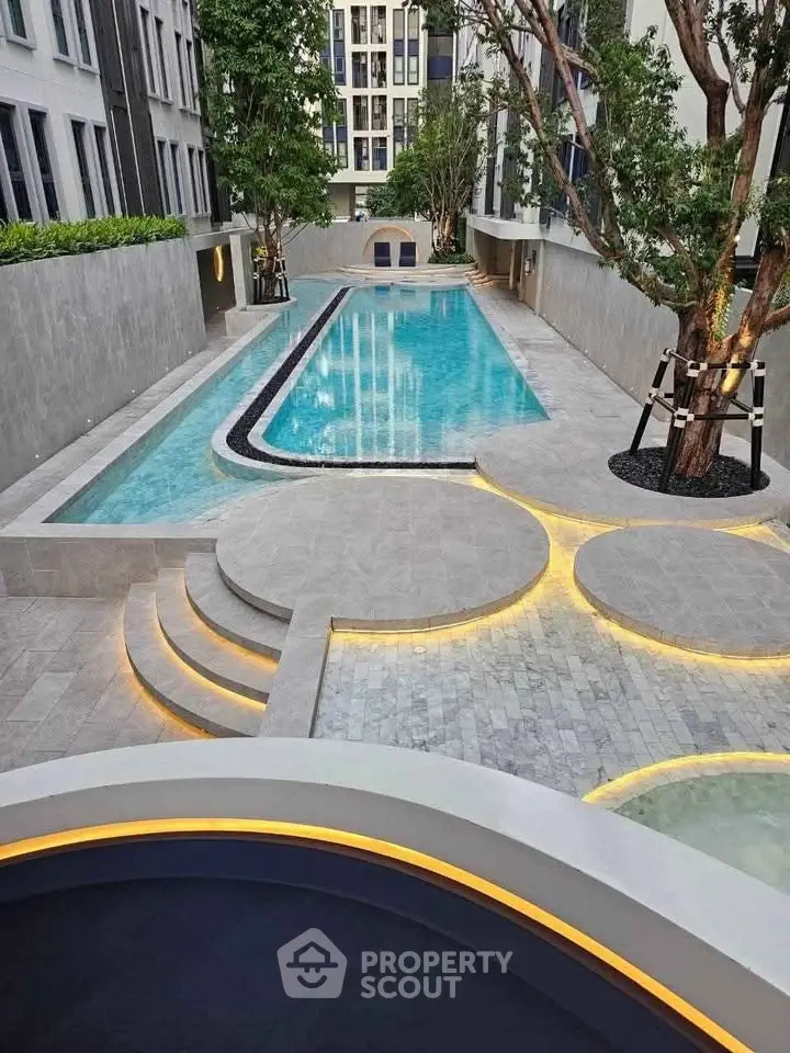 Luxurious modern apartment complex with a stunning outdoor pool and elegant landscaping.