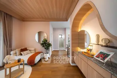 Stylish living room with modern decor, wooden ceiling, and cozy seating area, perfect for relaxation.