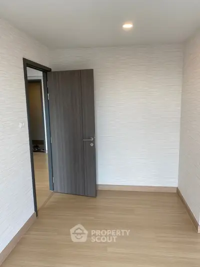 Minimalist interior with wooden flooring and open door in modern apartment