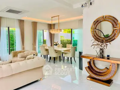 Luxurious living and dining area with elegant decor and large windows