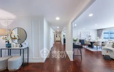 Spacious open-plan living area with elegant decor and hardwood floors