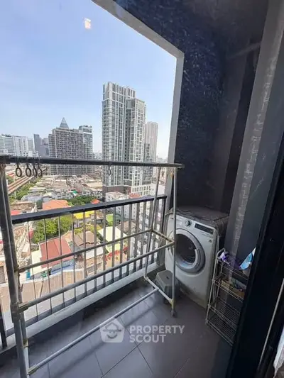 High-rise apartment balcony with city view and washing machine