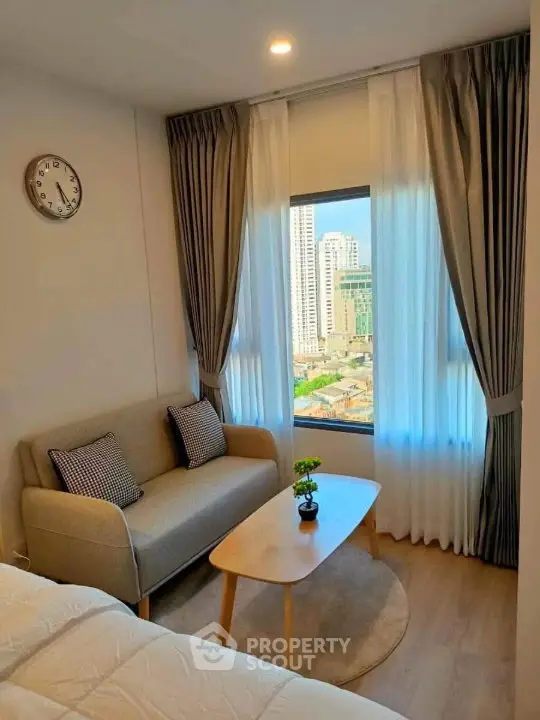 Cozy living room with city view, modern sofa, and elegant curtains in a high-rise apartment.