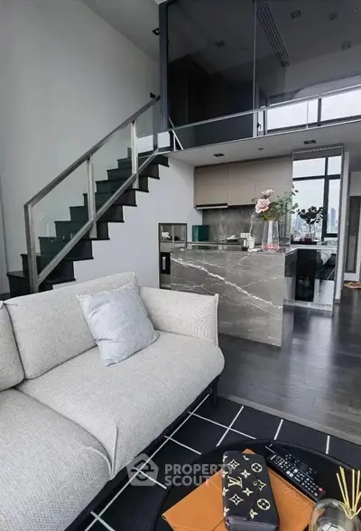 Modern loft apartment with stylish kitchen and cozy living area, featuring sleek staircase and elegant decor.