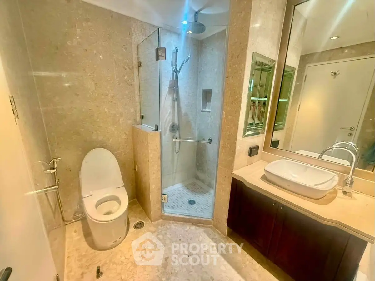 Luxurious bathroom with modern shower and elegant vanity in upscale property.