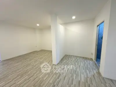 Spacious open-plan interior with modern tiled flooring and bright lighting, perfect for customization.