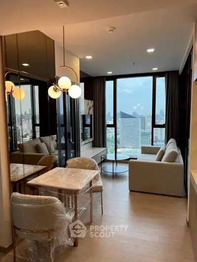 Modern living room with stunning city view, elegant furniture, and floor-to-ceiling windows in a high-rise apartment.