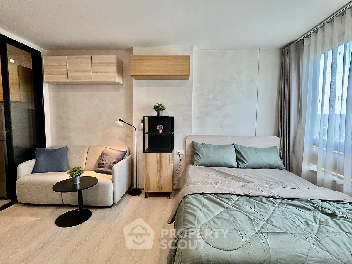 Modern studio apartment with cozy living area and stylish decor