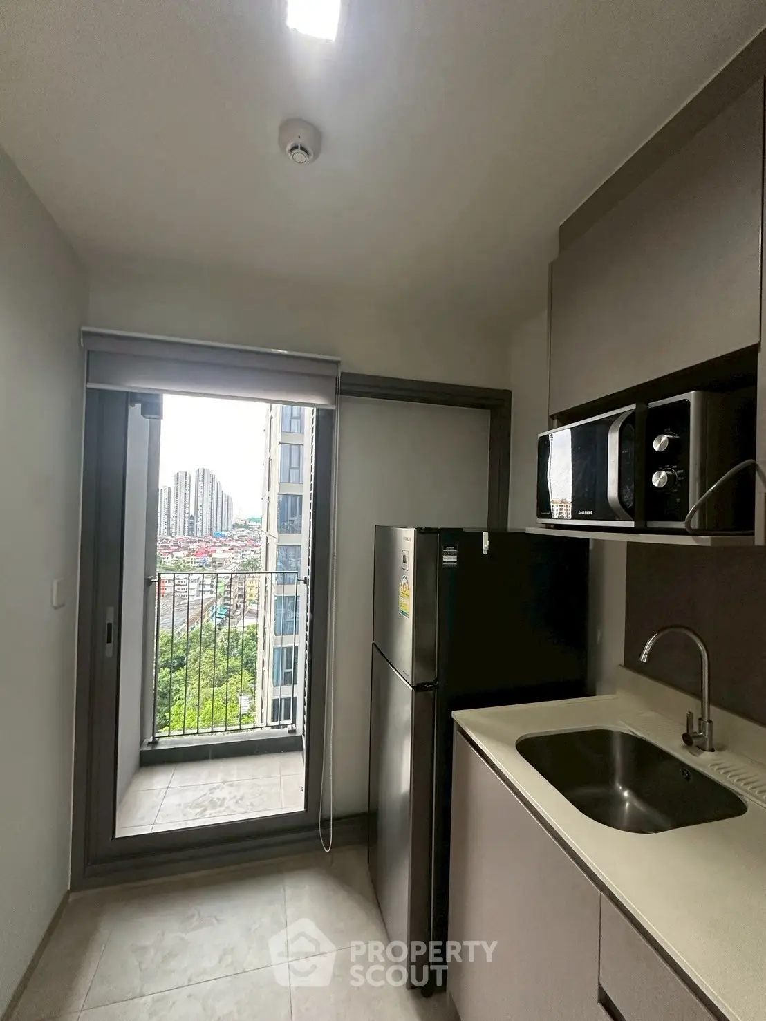 Modern kitchen with balcony view in high-rise apartment