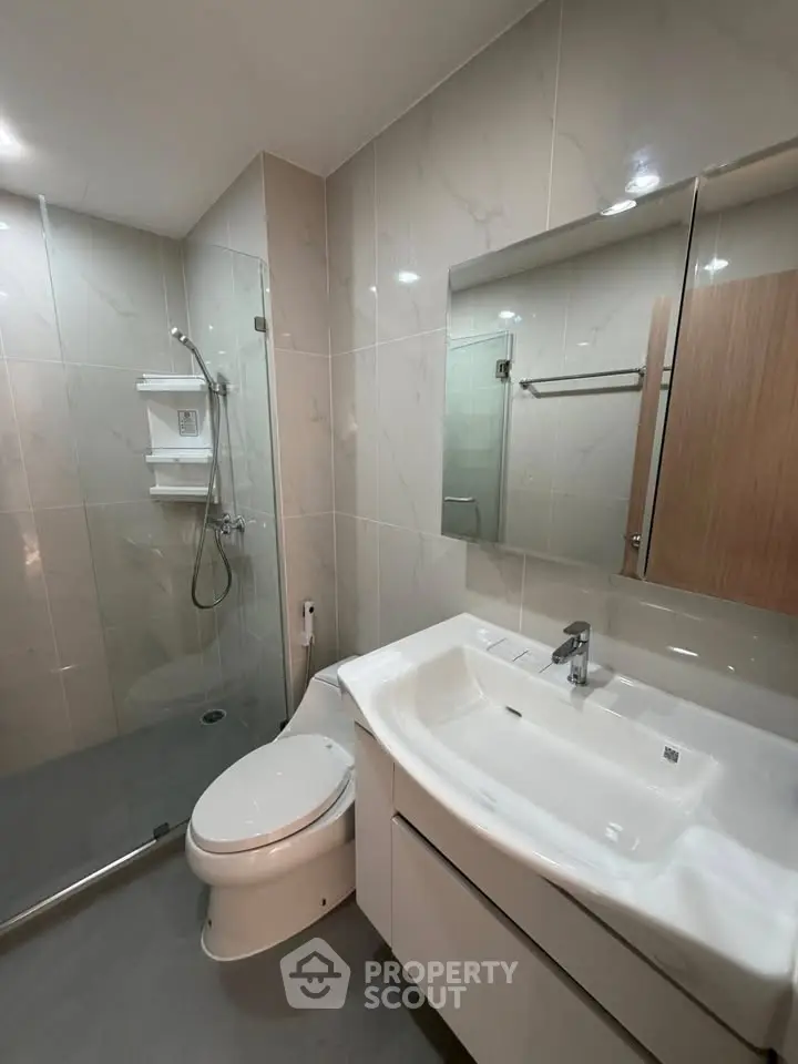 Modern bathroom with sleek fixtures and glass shower enclosure