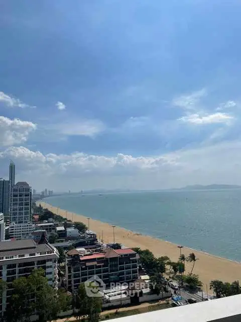 Stunning beachfront view from high-rise building overlooking ocean and cityscape.