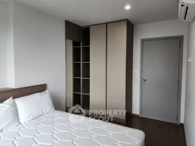 Modern bedroom with sleek wardrobe and comfortable bed in a stylish apartment.