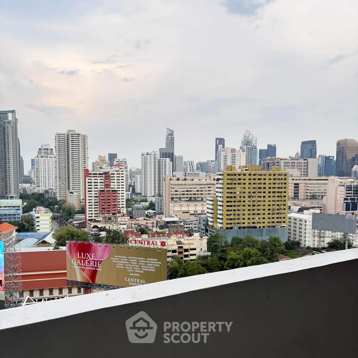 Stunning cityscape view from a high-rise balcony overlooking urban skyline.