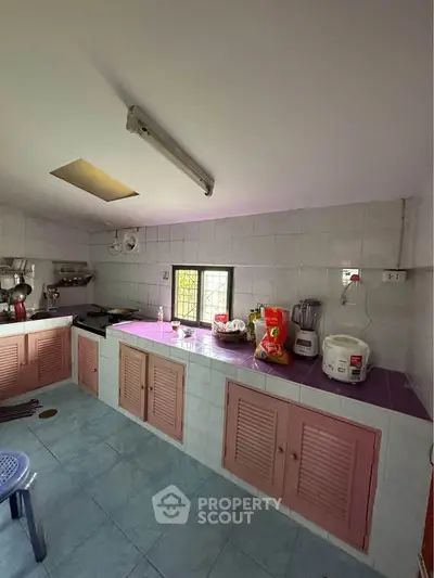 Charming kitchen with closed layout and essential appliances, featuring a cozy and functional design.