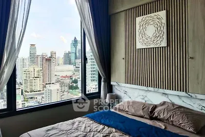 Luxurious bedroom with stunning city view in modern high-rise apartment.