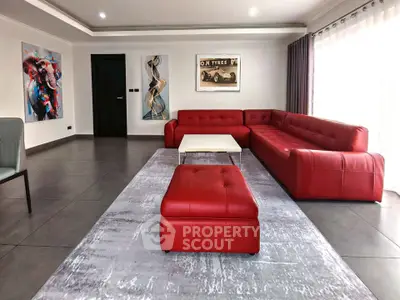 Spacious modern living room with red sectional sofa and stylish decor