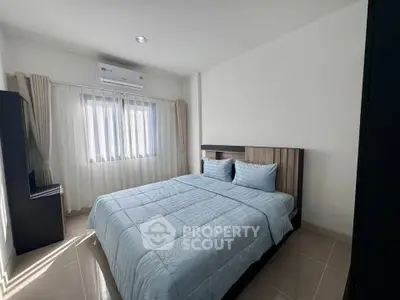 Spacious bedroom with modern decor and natural light