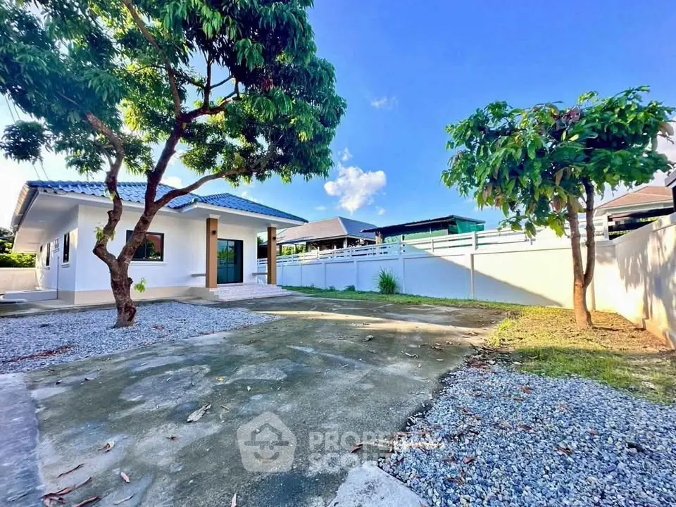 Charming single-story home with spacious yard and mature trees, perfect for family living.