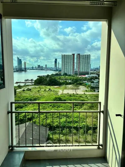 Stunning cityscape view from a balcony overlooking lush greenery and river, perfect for urban living.