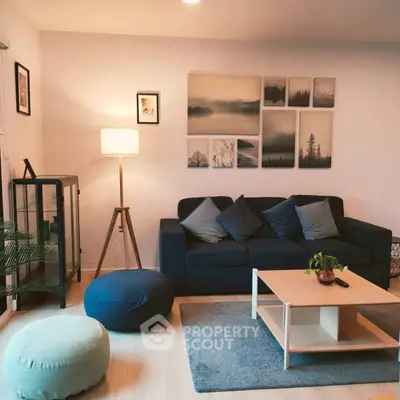 Stylish living room with modern decor, cozy seating, and elegant wall art for a welcoming ambiance.