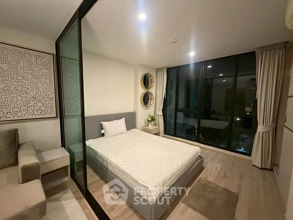 Modern bedroom with glass partition and cozy decor in a stylish apartment