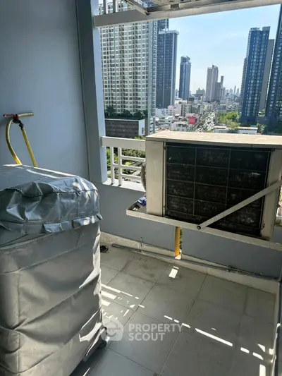 High-rise balcony with city view and air conditioning unit