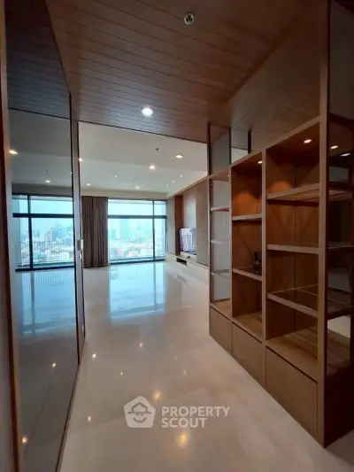 Spacious modern living room with city view and elegant wooden shelving
