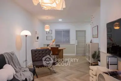 Stylish modern living room with elegant lighting and chic furniture, perfect for cozy gatherings.