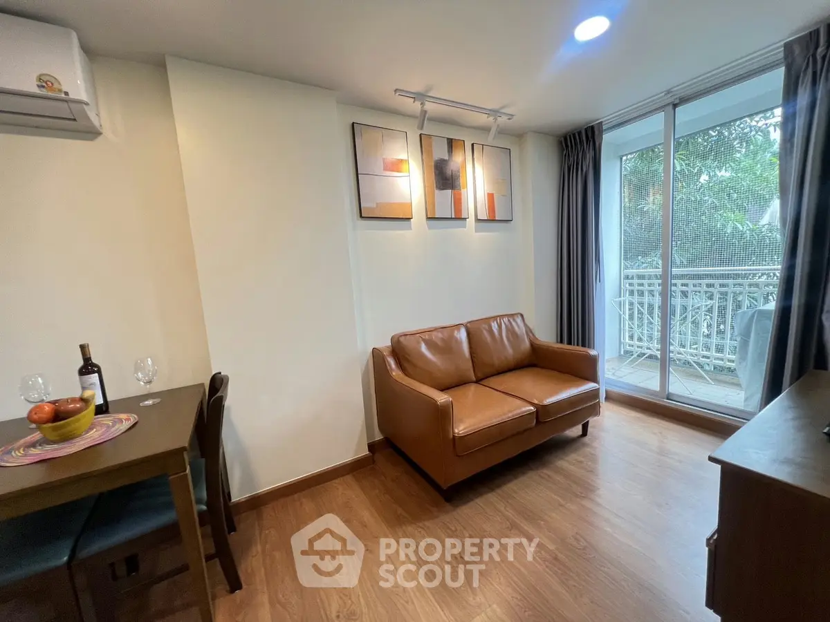 Cozy living room with leather sofa and balcony view in modern apartment