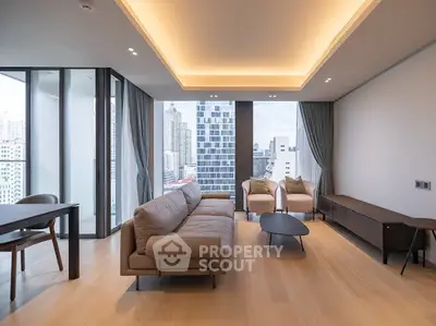 Modern living room with city view, featuring sleek furniture and floor-to-ceiling windows.
