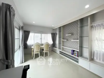 Elegant living room with modern built-in shelves and stylish dining area