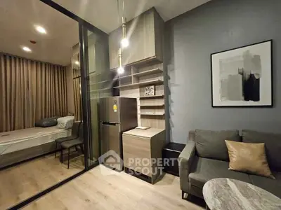 Modern studio apartment with sleek design, featuring a cozy living area and compact kitchen.