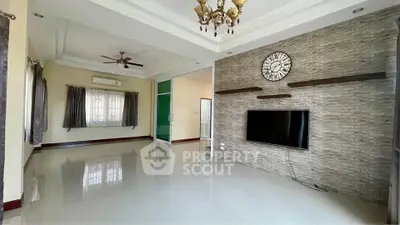 Spacious living room with modern decor and wall-mounted TV