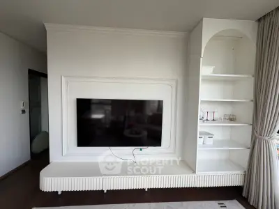 Modern living room with built-in TV and elegant shelving unit