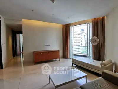 Spacious modern living room with city view and elegant furnishings.