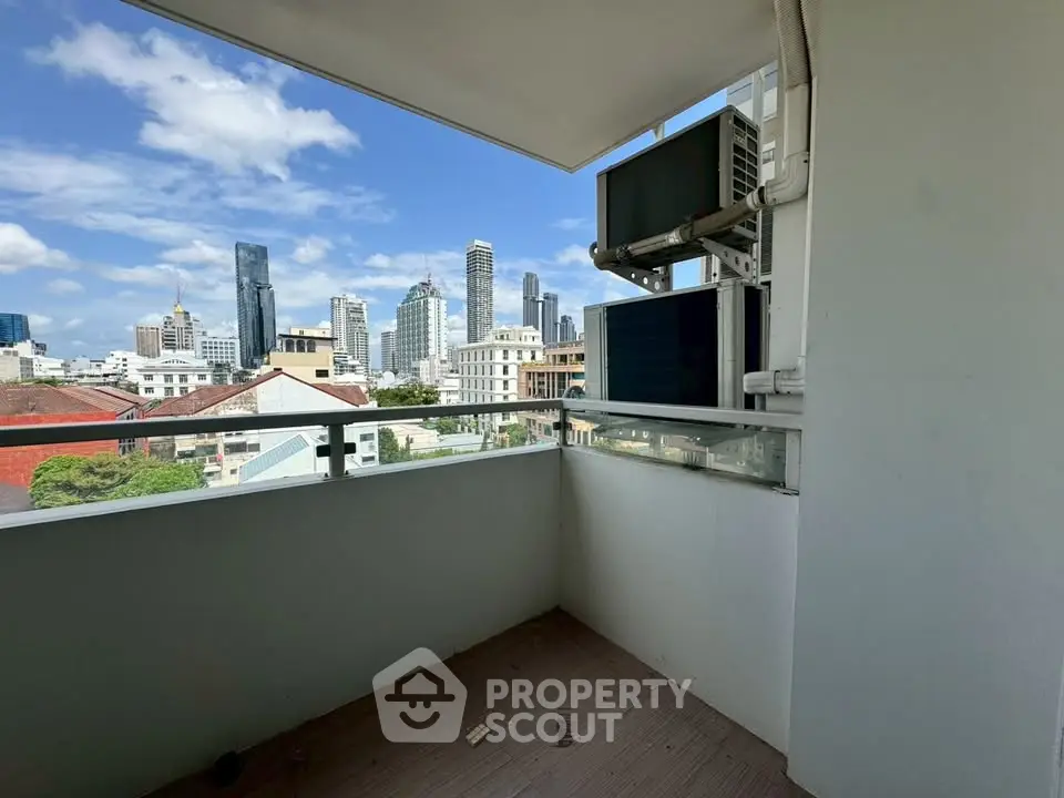 Spacious balcony with stunning city skyline view, perfect for urban living.