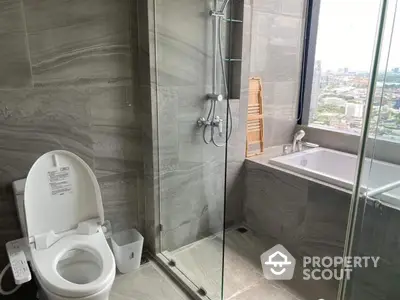 Luxurious bathroom with city view, featuring modern shower and bathtub.