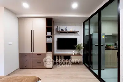 Modern living room with sleek storage and open kitchen layout