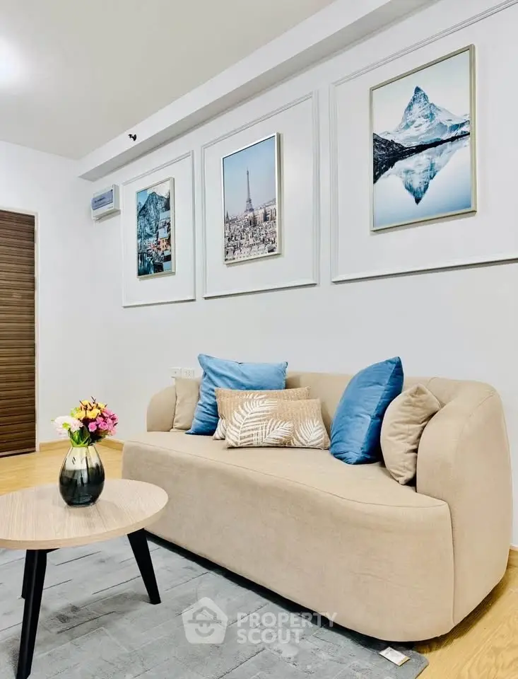 Stylish living room with modern decor, featuring a cozy beige sofa, elegant wall art, and a chic coffee table.