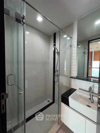 Modern bathroom with glass shower and sleek sink design