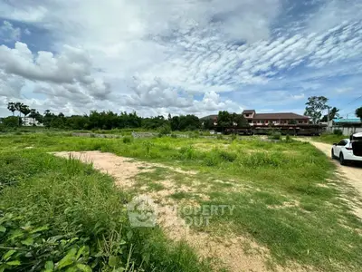 Expansive land plot with lush greenery and clear skies, ideal for development opportunities.