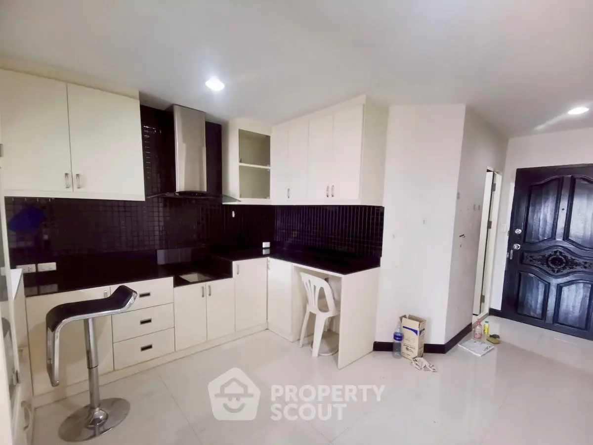 Modern kitchen with sleek black countertops and white cabinetry