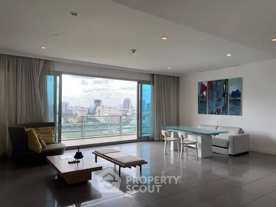 Spacious modern living room with stunning city view and elegant furnishings.