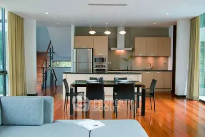 Modern open-plan kitchen and dining area with sleek design and natural light.