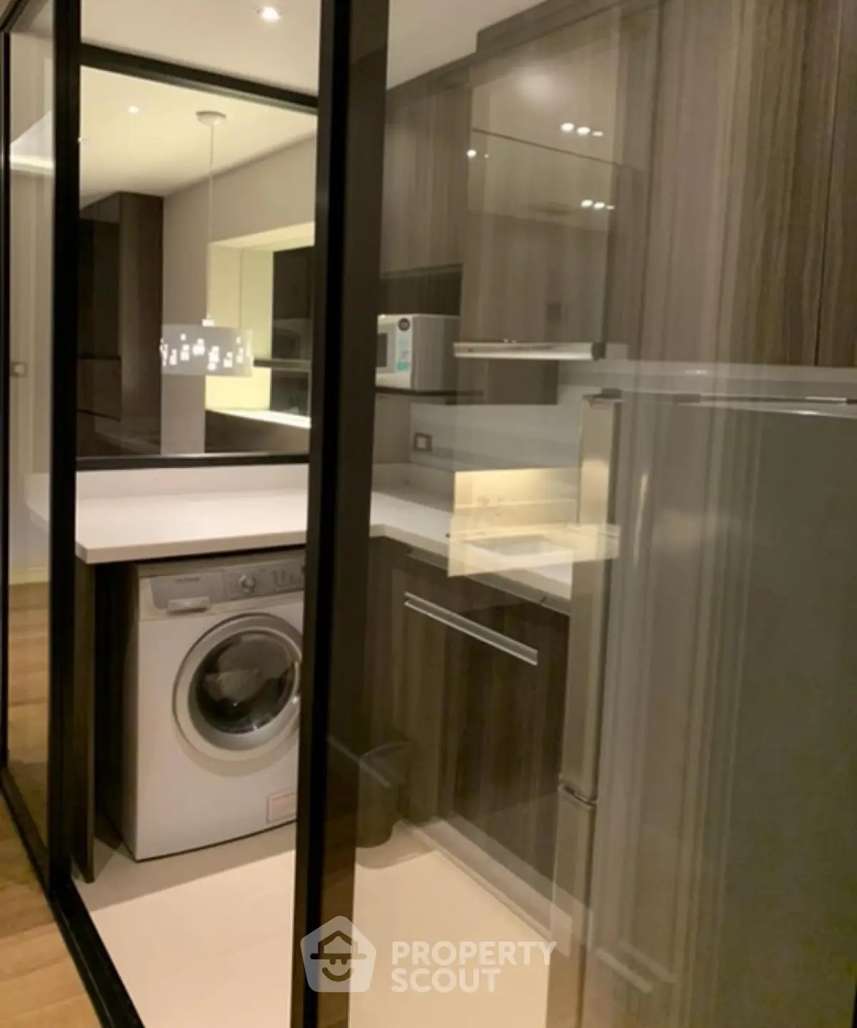 Modern kitchen with sleek cabinetry and built-in washing machine