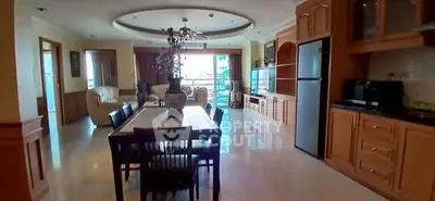 Spacious open-plan living and dining area with modern kitchen and natural light.