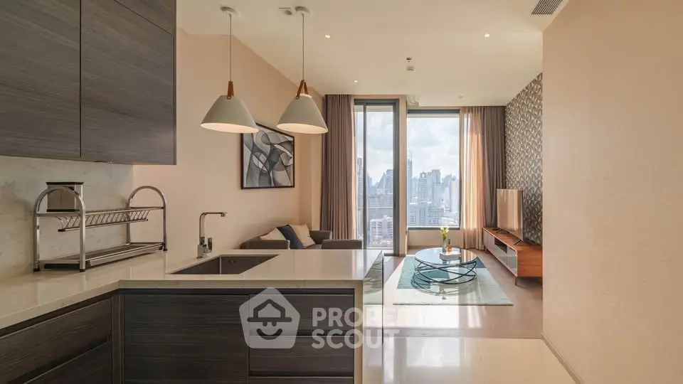 Modern open-layout kitchen and living room with city view, stylish decor, and ample natural light.